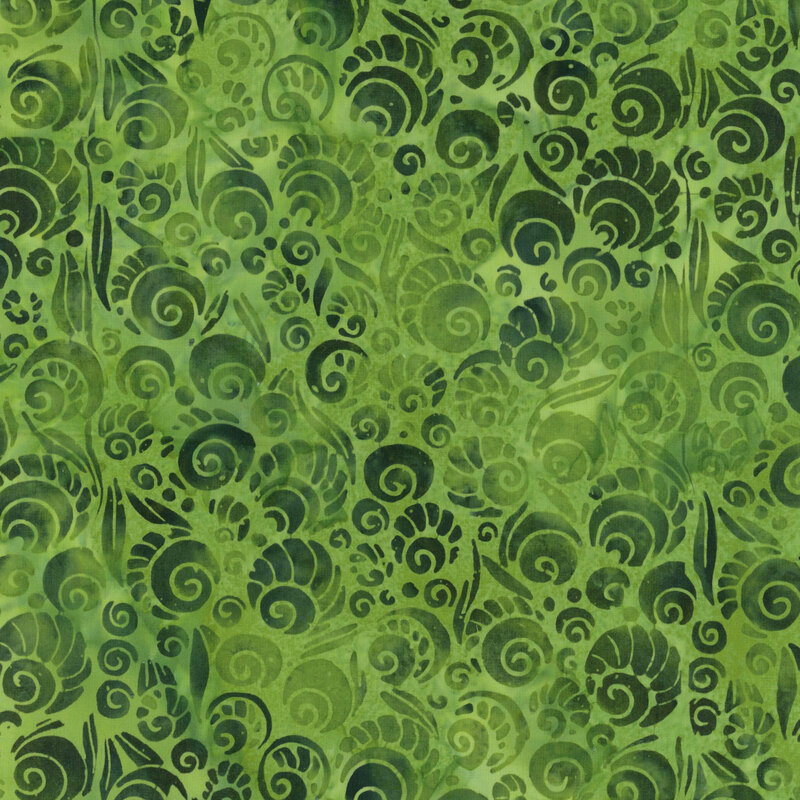 Mottled green batik fabric with darker tonal swirls with designs to make them look like shells.