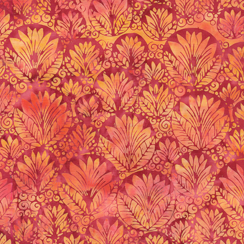 Mottled red batik fabric with an ornamental, overlapping design of circular shapes filled with leaves and swirls in orange, yellow, and pink.