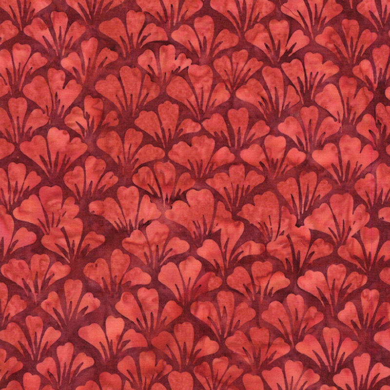 Mottled red batik fabric with overlapping rows of fanned out tonal flower petals.