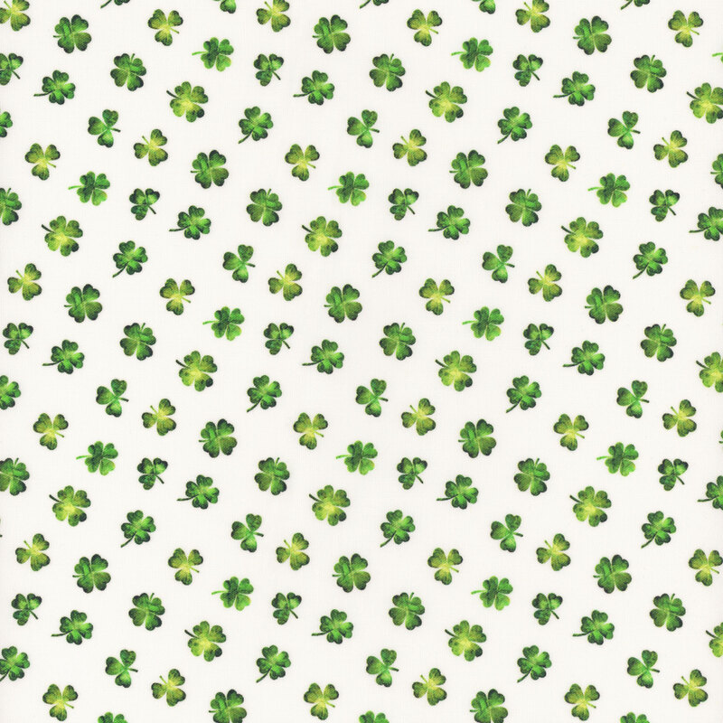 Seamless pattern of small green clovers and shamrocks on a white fabric.