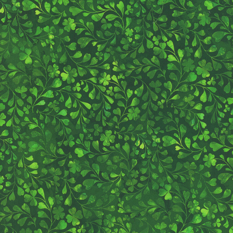 Lush green foliage pattern with various shades and textures of leaves.
