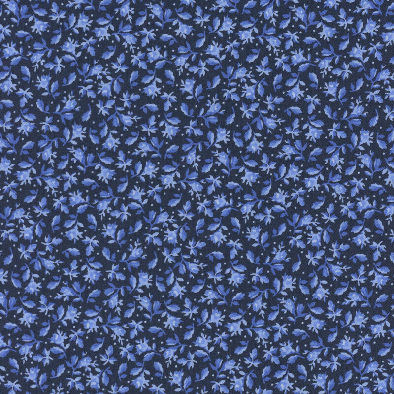 Navy blue fabric decorated with small leaves and florals amongst scattered pinprick dots.