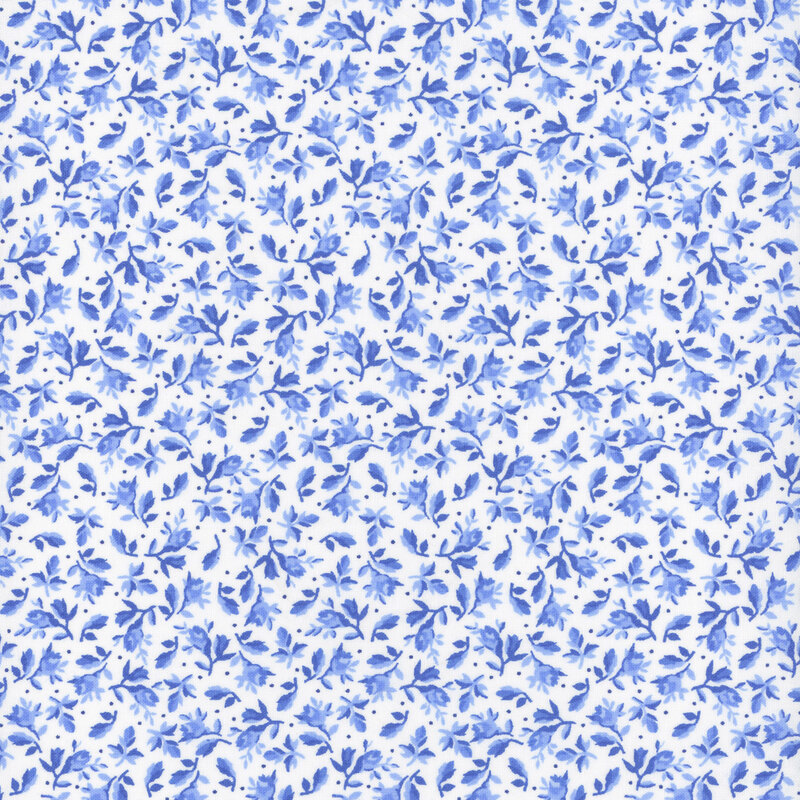 White fabric decorated with small leaves and florals amongst scattered pinprick dots.