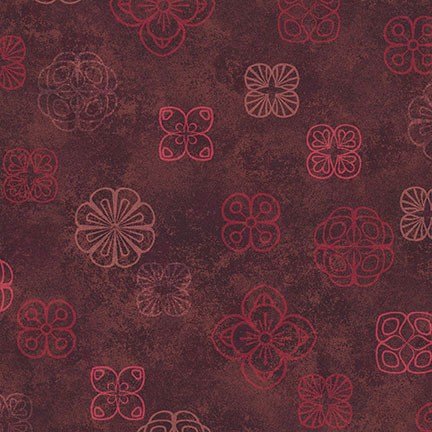 A patterned fabric featuring various flower shapes in red and light brown on a dark brown background.