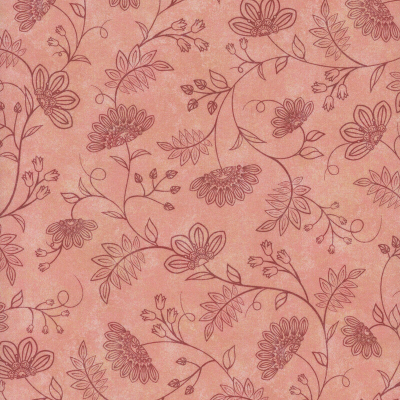 Floral pattern on a pink fabric featuring swirling vines and stylized flowers.