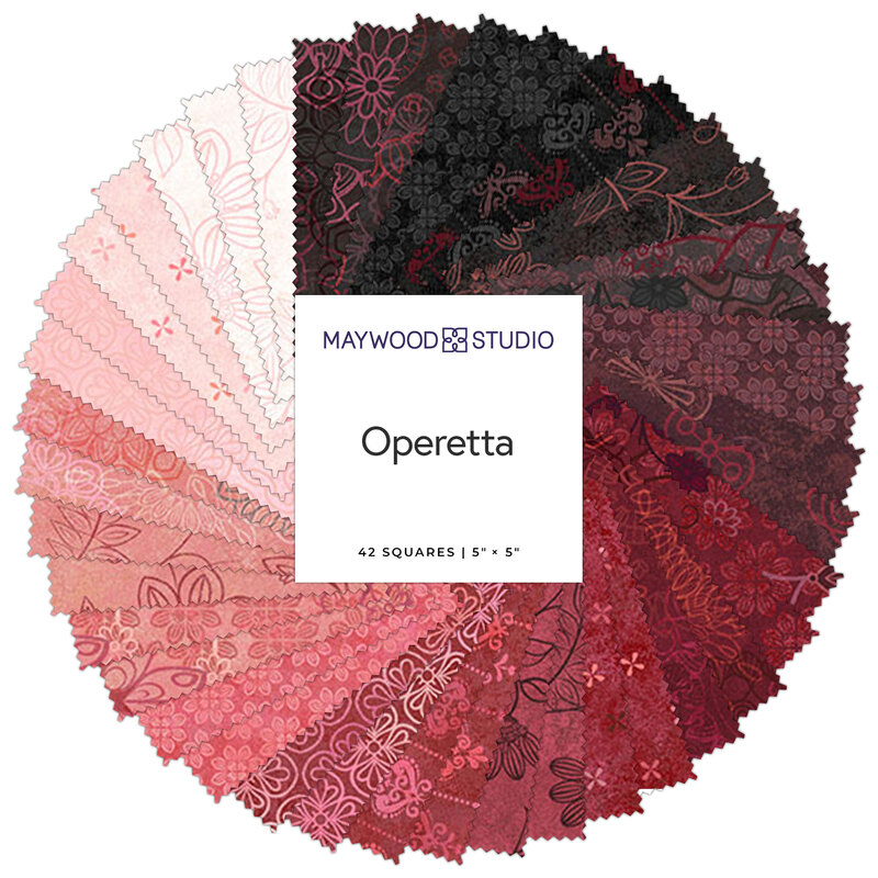 A stack of fabric squares in various shades of red and pink, featuring floral patterns.