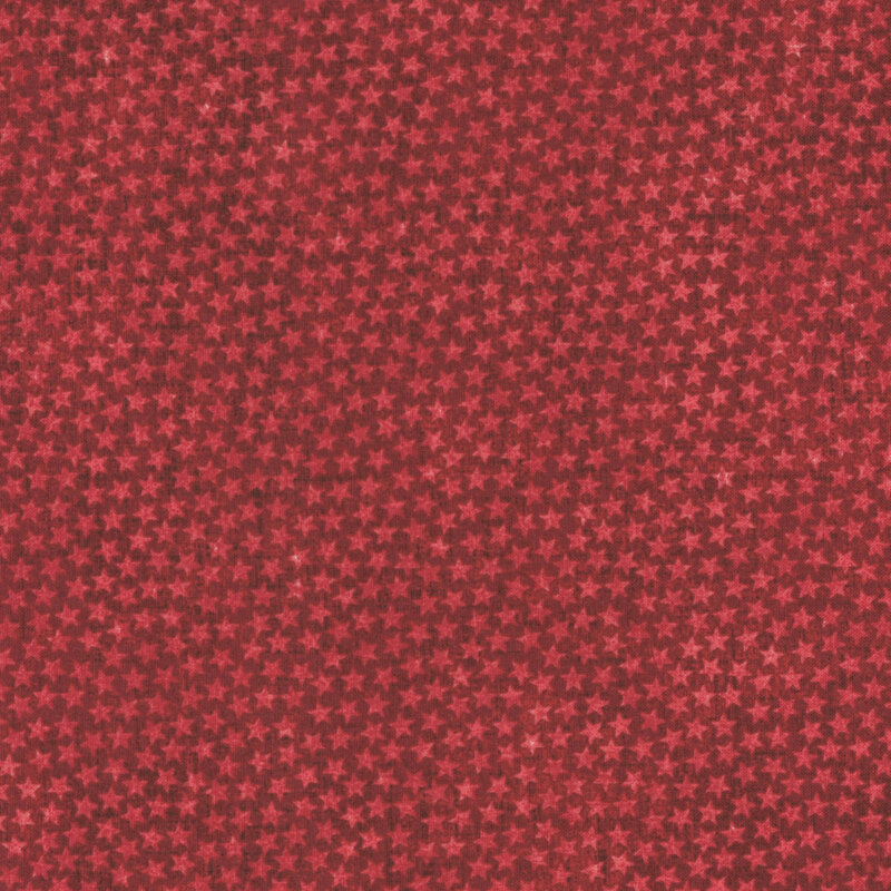 Red fabric pattern with a tonal small dense star pattern. 