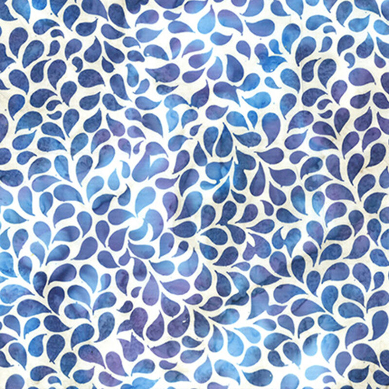 Mottled batik fabric with blue and purple petals tossed on a white fabric.