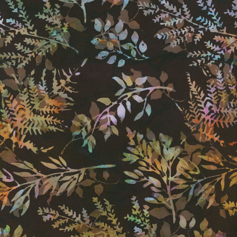 Multicolor leaf silhouettes of tossed on a soft black fabric.