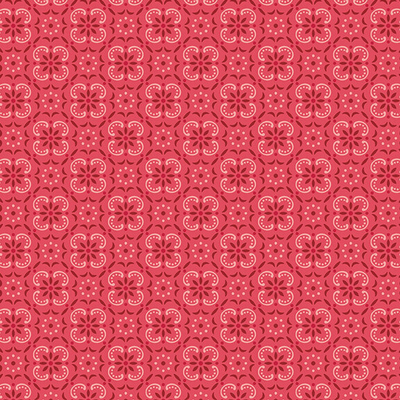 Rose red fabric with a geometric and tonal floral emblem pattern. 