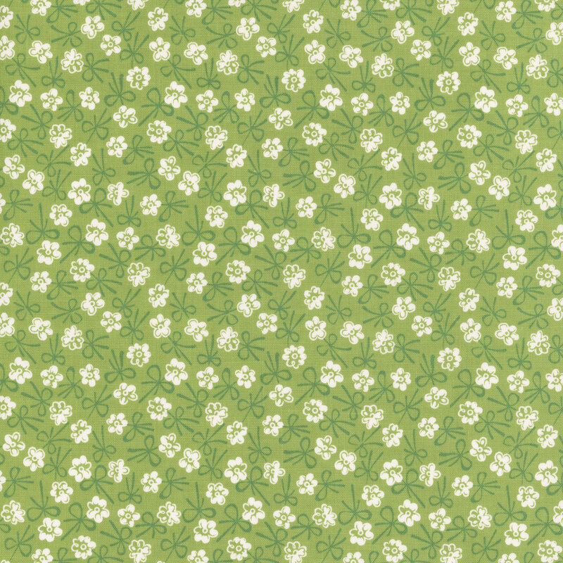 Leaf green fabric with a white floral and tonal bow design.