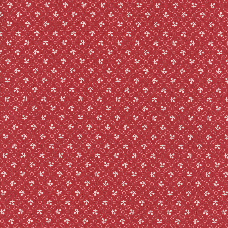 Rose red fabric with uniform rows of geometric leaves and white sprigs.