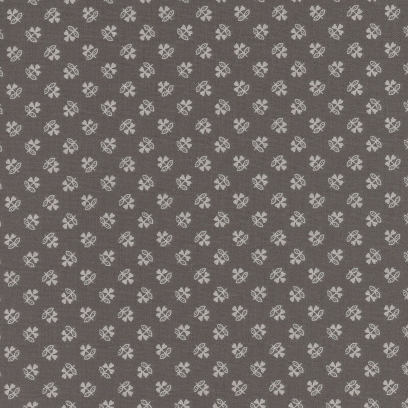 Warm gray fabric with a tonal ditsy pattern of stylized clovers.