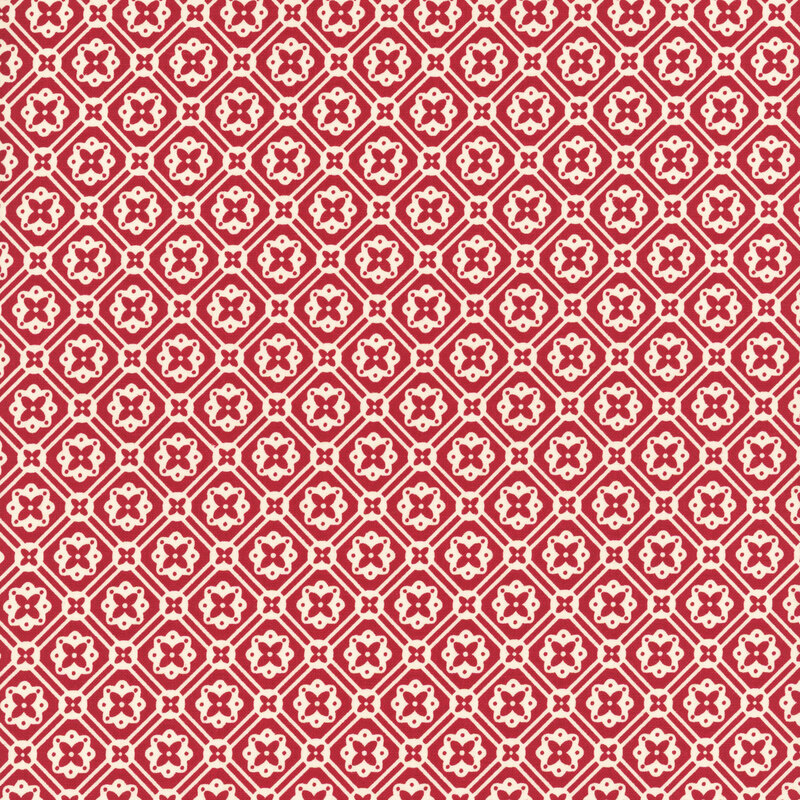 Bright red fabric with a geometric white floral emblem pattern.