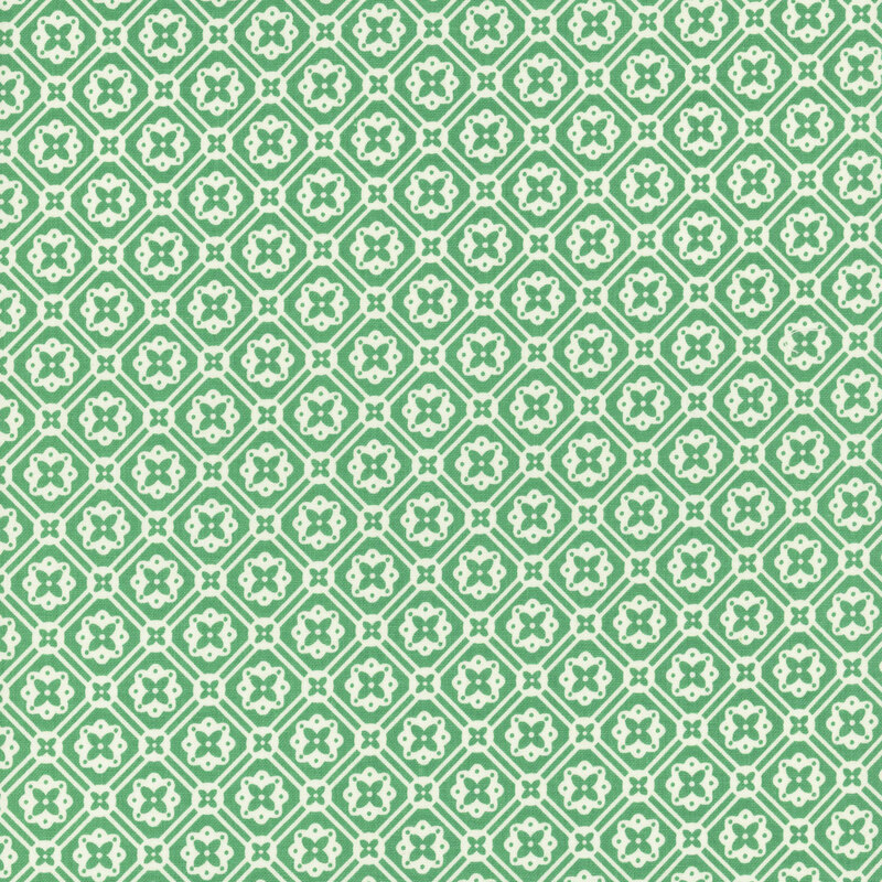 Bright alpine green fabric with a geometric white floral emblem pattern.