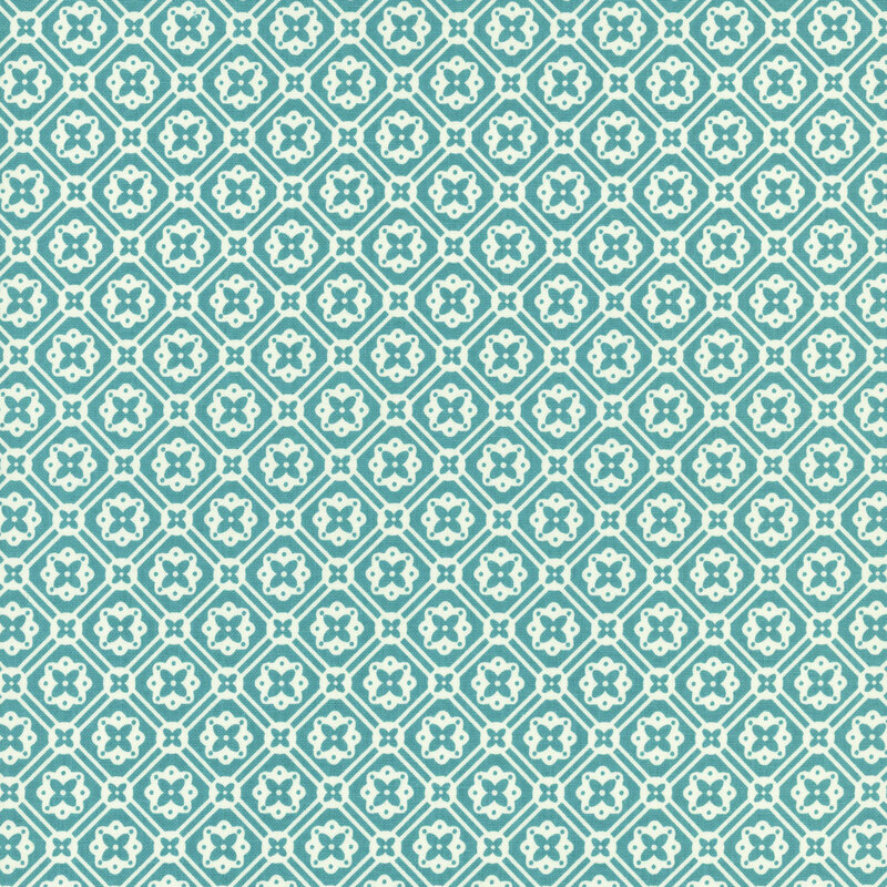 Bright teal fabric with a geometric white floral emblem pattern.
