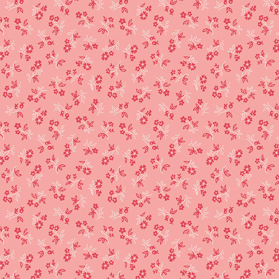 Pink fabric with a red and white ditsy floral design.