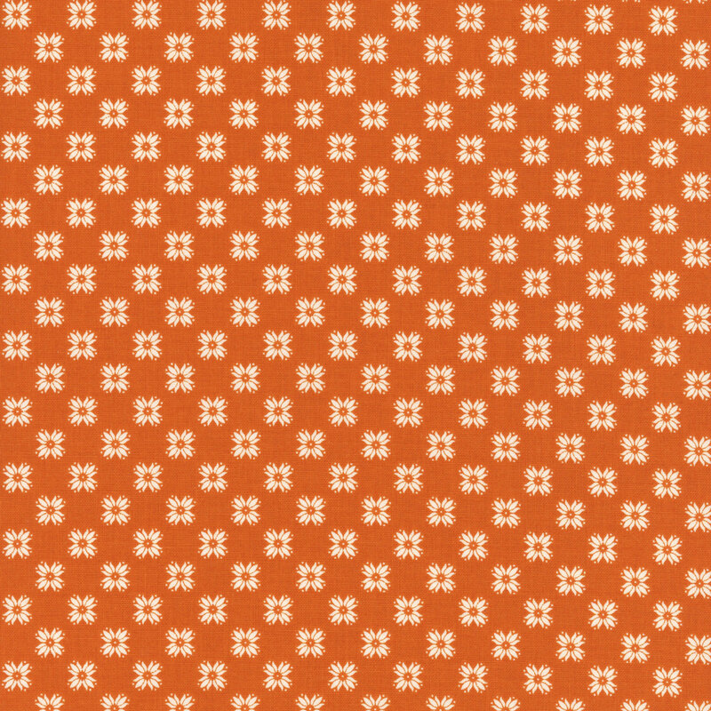 Orange fabric with a uniform white floral emblem design.