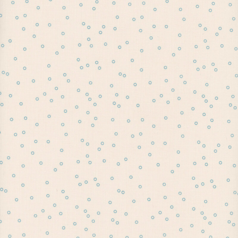 Cream fabric with scattered teal dots.