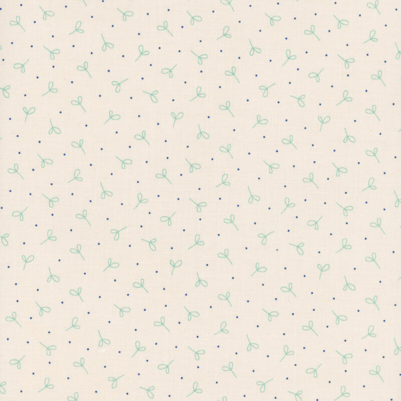 Cream fabric with ditsy teal sprigs and dark blue dots.