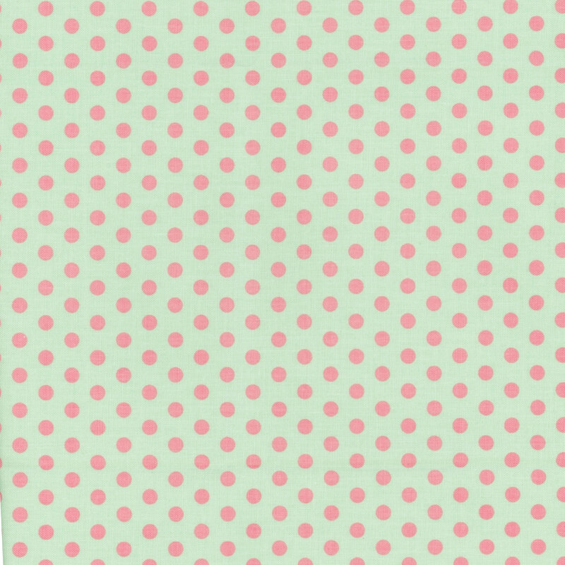 Mint green fabric with classic pink polka dots.