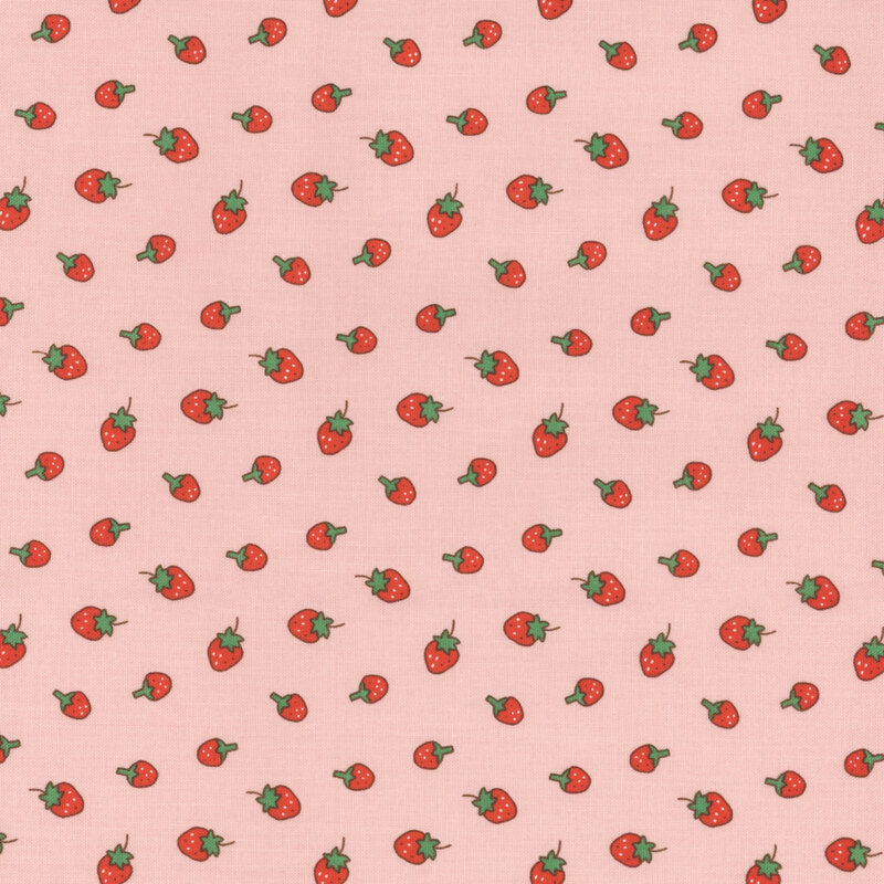 Pink fabric with a ditsy red strawberry pattern.