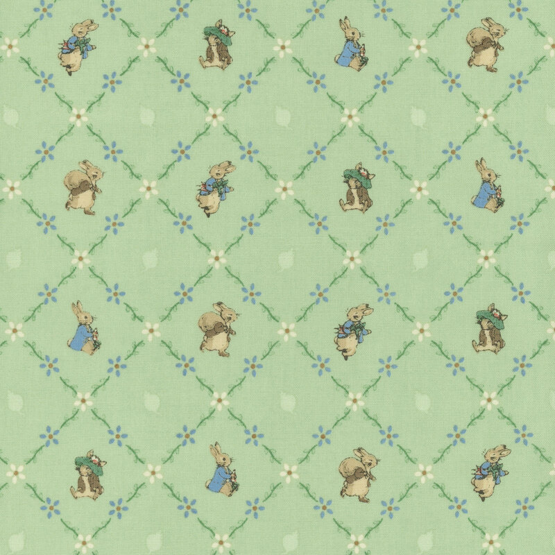 The storybook rabbits, Peter and Benjamin, pose inside floral lattice on green fabric.