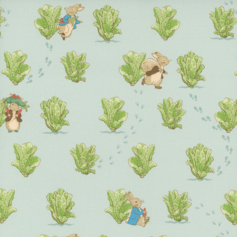 Storybook rabbits, Peter and Benjamin, are surrounded by the garden lettuce on light blue fabric.