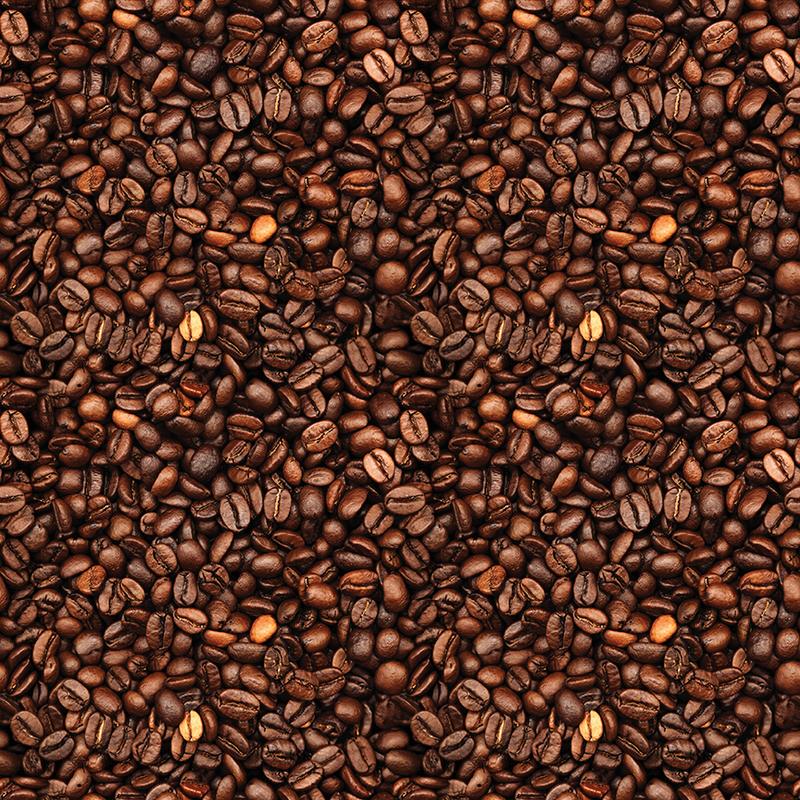 Close-up of a textured surface covered with various roasted coffee beans in rich brown tones.