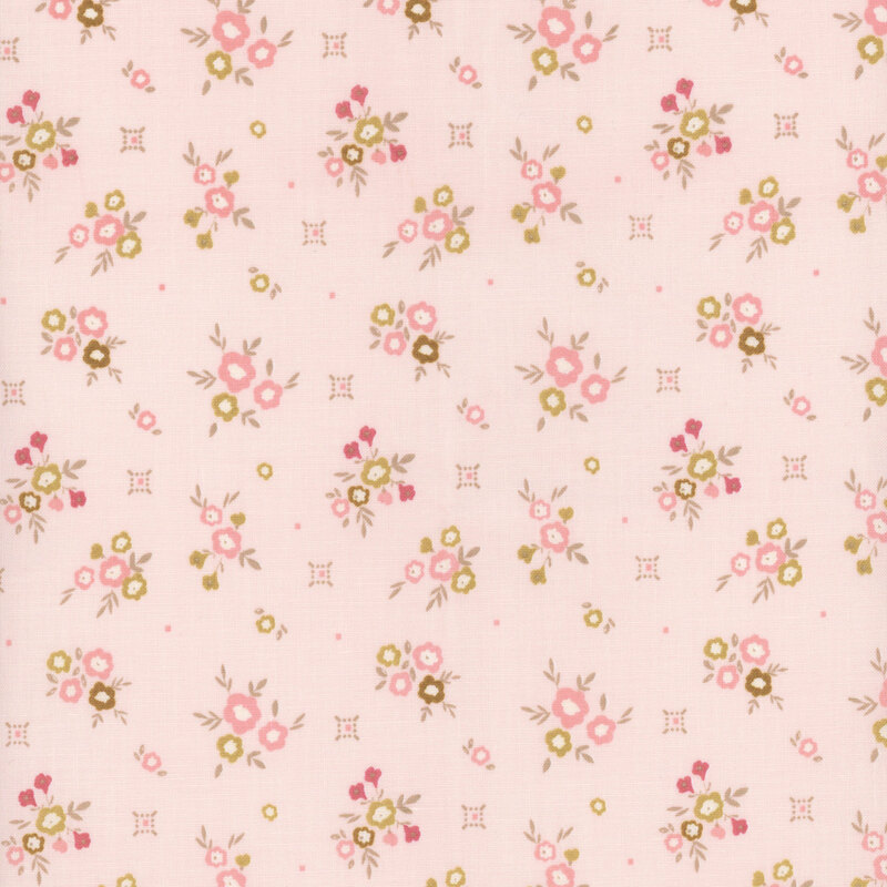 Pale pink fabric with small floral clusters and small primitive designs in gold and tonal pink.