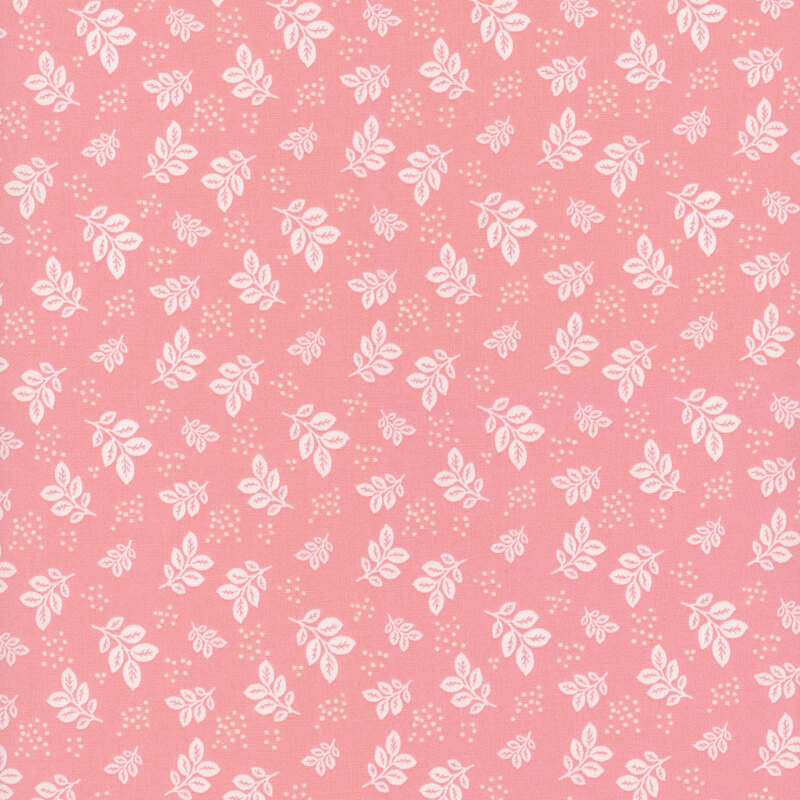 Coral pink fabric with white leaves and clusters of pin dots.
