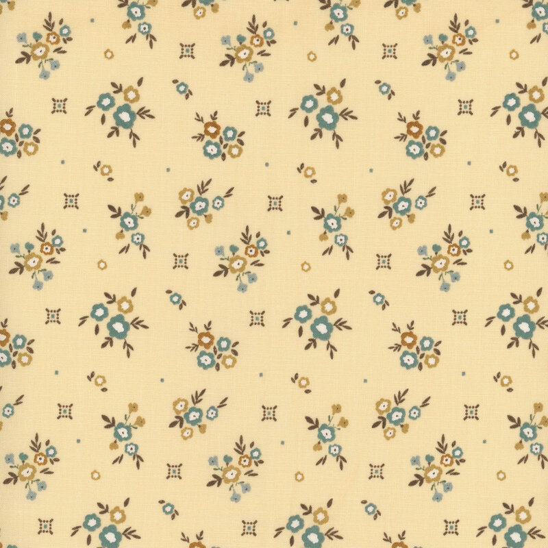 Pale gold fabric with small floral clusters and small primitive designs in teal and tonal gold.