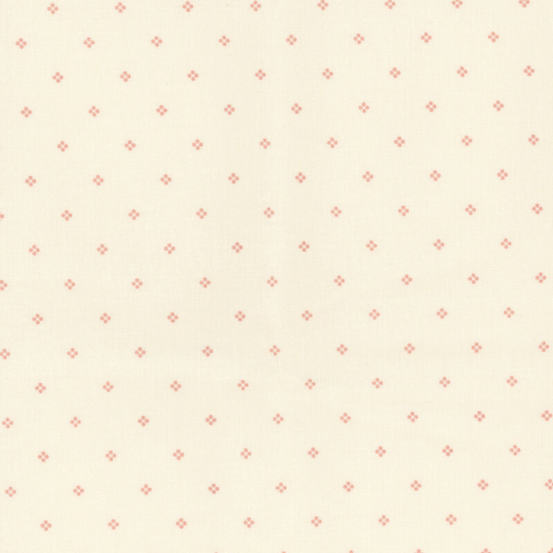 Cream fabric with a subtle pattern of small red dots.