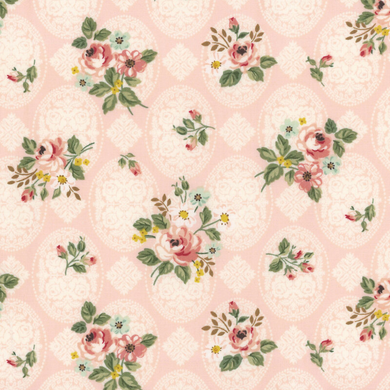 Light pink fabric decorated with an intricate floral pattern and tossed with bunches of roses and greenery.