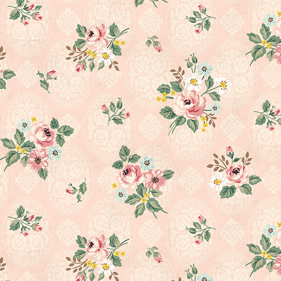 Light pink fabric decorated with an intricate floral pattern and tossed with floral designs of roses and greenery.