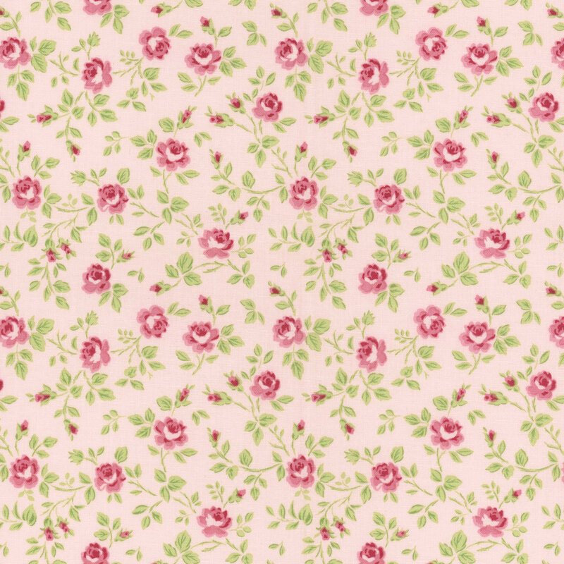 Pink fabric with tossed green leaves and pink buds.