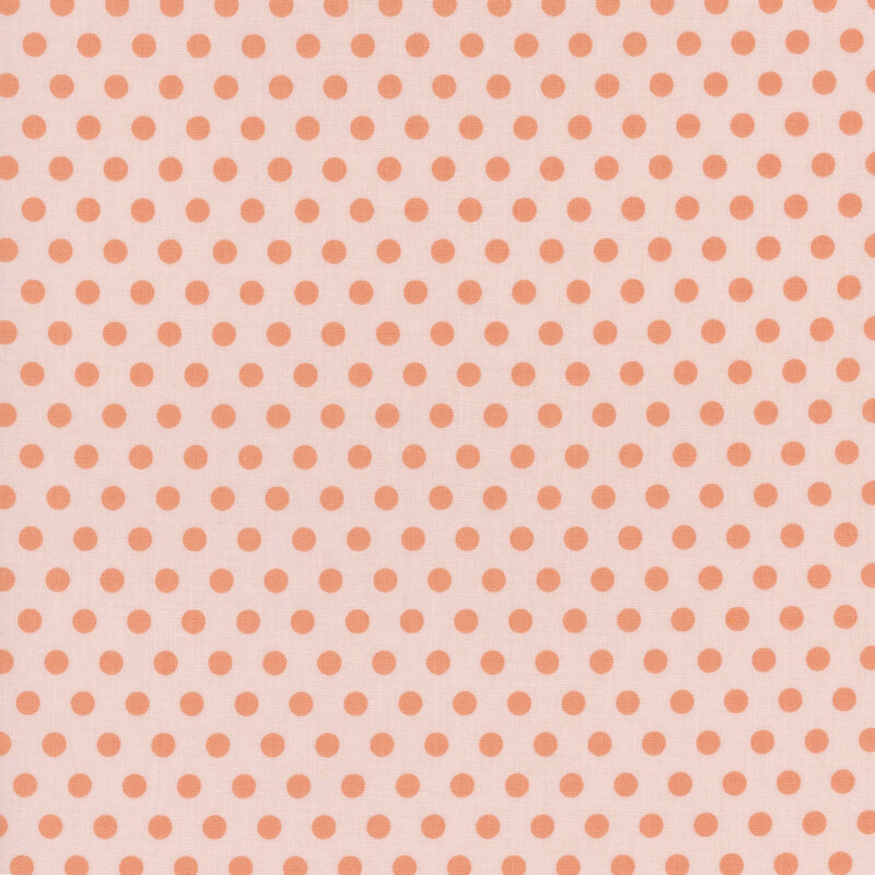 Light peach fabric covered in evenly spaced orange polka dots.