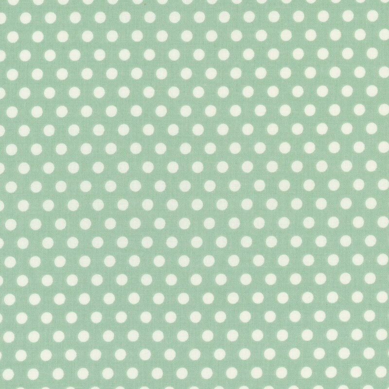 Mint green fabric with a repetitive pattern of white polka dots.
