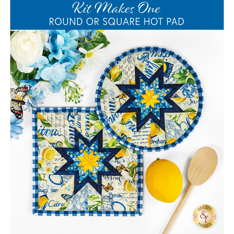 The two completed white Folded Star Hot Pads, one round and one square, slightly overlapping each other and staged on a white table with coordinating florals, decor, and wooden spoons.