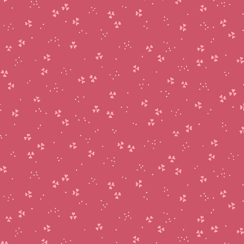 A raspberry colored background with small white floral patterns scattered throughout.