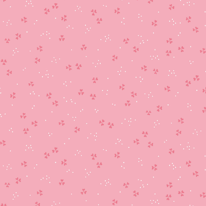 A pink background featuring small white and darker pink floral patterns distributed evenly.