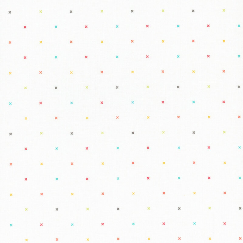 White fabric with small multicolored x's that resemble cross stitching.
