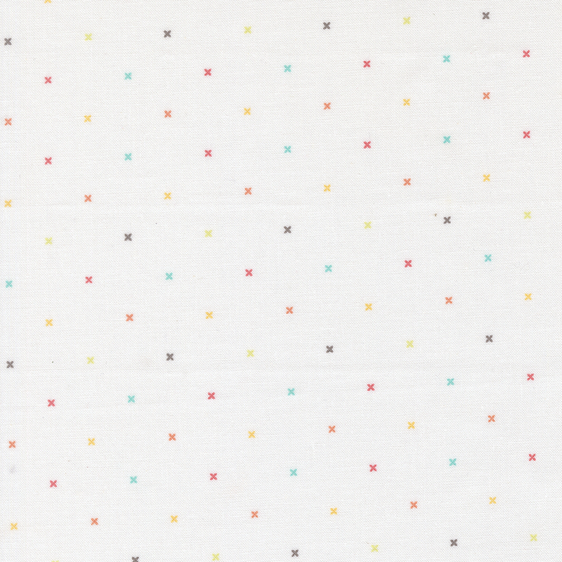 White fabric with small multicolored x's that resemble cross stitching.
