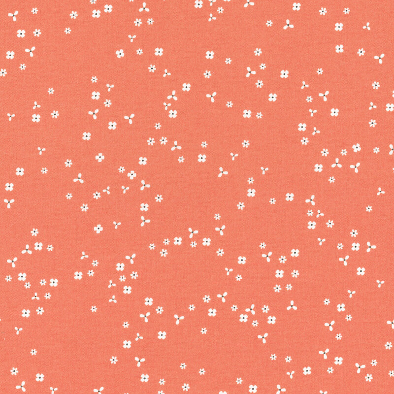 Coral orange fabric with scattered, tiny white flower blossoms.