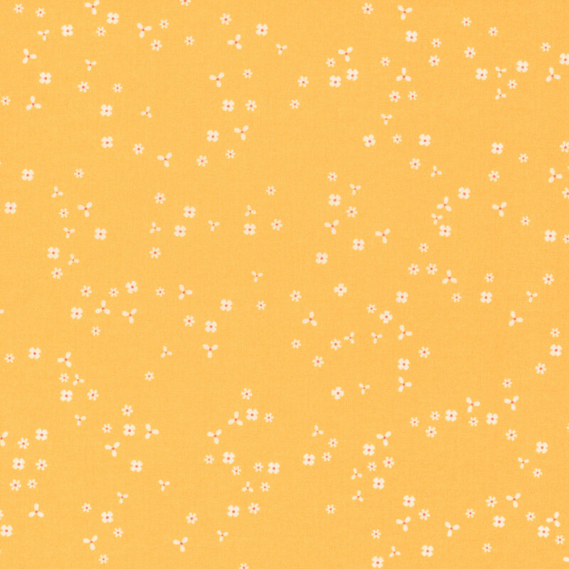 Golden yellow fabric with scattered, tiny white flower blossoms.