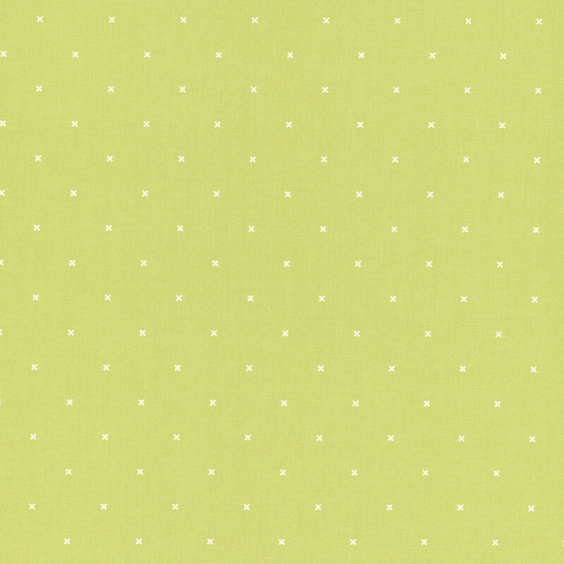 Light lime green fabric with small x's that resemble cross stitching.