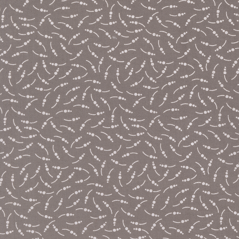 Slate gray fabric with abstract dots and lines scattered across the design.