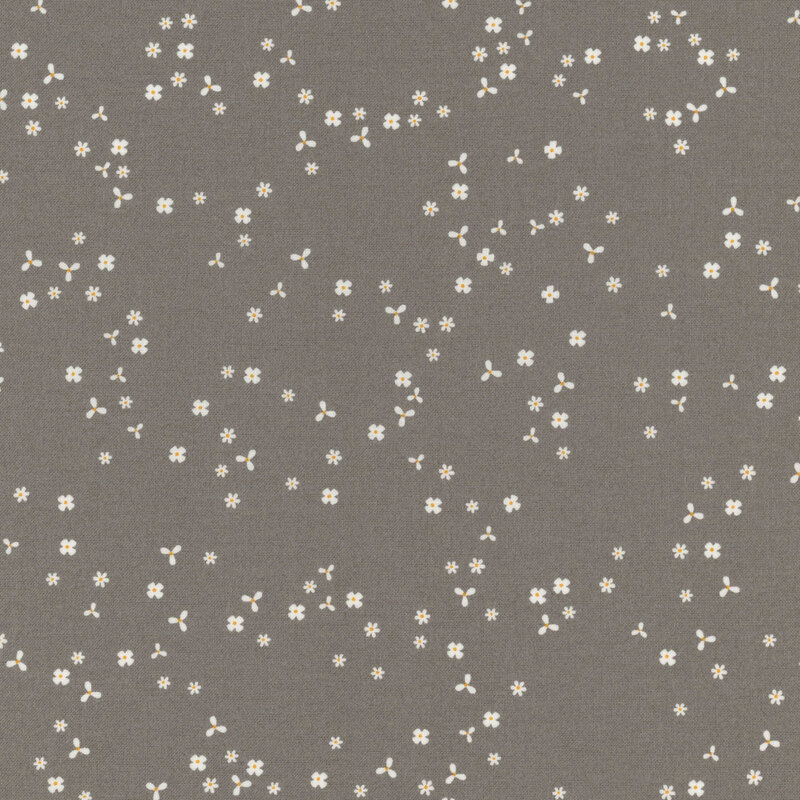 Stone gray fabric with scattered, tiny white flower blossoms.