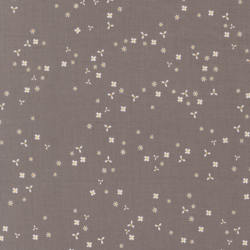 Stone gray fabric with scattered, tiny white flower blossoms.