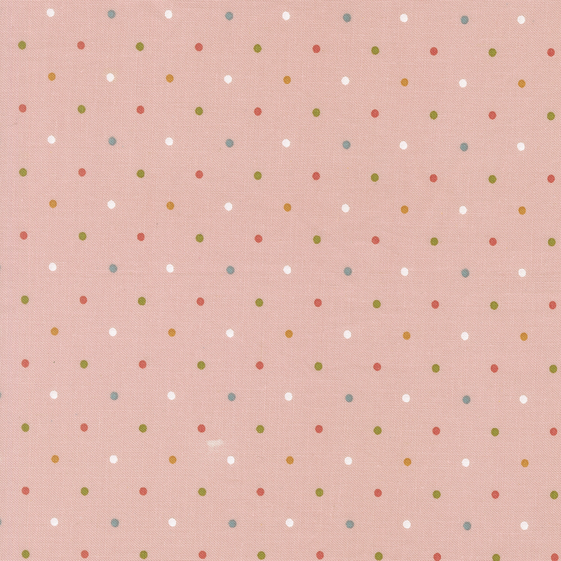 Light pink fabric with a multicolored polka dot pattern.